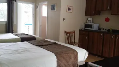 a hotel room with two beds and a microwave at AppleTree Inn in Radium Hot Springs