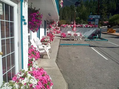 a street with chairs and flowers on the side of a building at AppleTree Inn in Radium Hot Springs