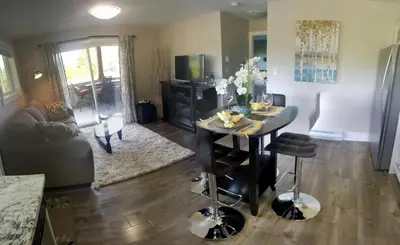 a living room with a table and a couch at Cowichan Calling in Lake Cowichan