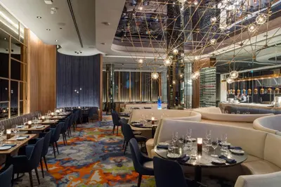 a restaurant with tables and chairs and a bar at Delta Hotels by Marriott Burnaby Conference Centre in Burnaby