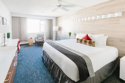 a hotel room with a large bed with red pillows at Elk + Avenue Hotel in Banff