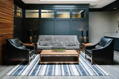 a living room with a couch and chairs and a table at Elk + Avenue Hotel in Banff