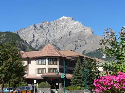 a building with a mountain in the background at Elk + Avenue Hotel in Banff