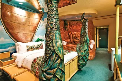 a bedroom in a hotel with a bed in front of a wall at Fantasyland Hotel in Edmonton