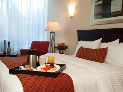 a hotel room with a tray of food on a bed at Fantasyland Hotel in Edmonton