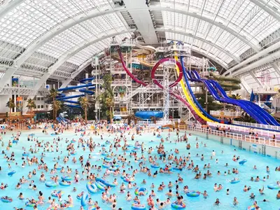 a crowd of people in a pool at a water park at Fantasyland Hotel in Edmonton