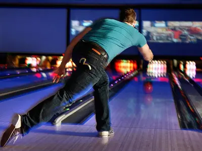 a man is playing a game of bowling at Fantasyland Hotel in Edmonton
