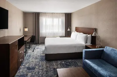 a hotel room with a bed and a couch at Four Points by Sheraton Edmonton South in Edmonton