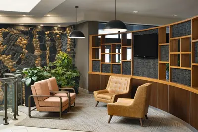 a waiting room with chairs and a tv at Four Points by Sheraton Edmonton South in Edmonton