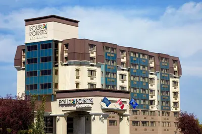 a hotel building with a trumpumps sign on it at Four Points by Sheraton Edmonton South in Edmonton