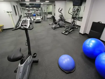 a gym with several exercise bikes and exercise balls at Sawridge Inn and Conference Centre Edmonton South in Edmonton