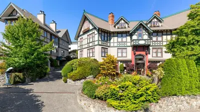 a large house with a garden in front of it at Abigail's Hotel in Victoria