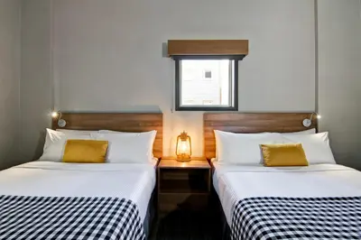 two beds sitting next to each other in a room at Canalta Lodge in Banff