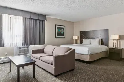 a hotel room with a bed and a couch at Radisson Hotel & Conference Centre Edmonton in Edmonton