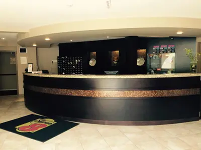 a bar in a restaurant with a counter at Super 8 by Wyndham West Kelowna BC in West Kelowna