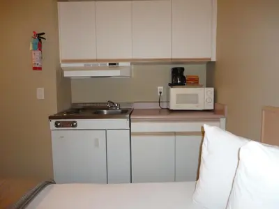 a small kitchen with a sink and a microwave at Super 8 by Wyndham West Kelowna BC in West Kelowna