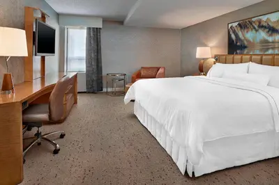 a hotel room with a bed and a desk and a computer at The Westin Edmonton in Edmonton