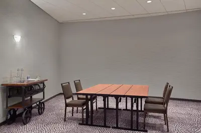 a dining room with a wooden table and chairs at The Westin Edmonton in Edmonton
