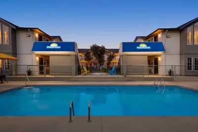 a swimming pool in front of a hotel at Days Inn by Wyndham Kelowna in Kelowna