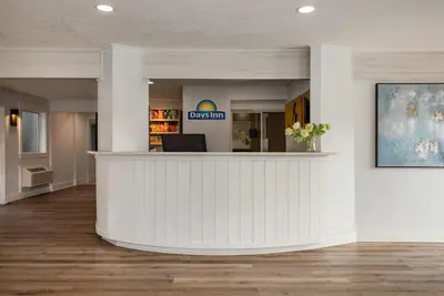 a lobby of a dental office with a reception counter at Days Inn by Wyndham Kelowna in Kelowna