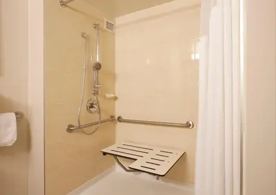 a bathroom with a shower and a bath tub at Holiday Inn Vancouver-Centre Broadway by IHG in Vancouver