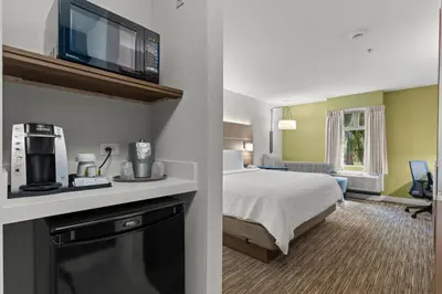 a hotel room with a bed and a hotel room with a room at Holiday Inn Express and Suites Surrey by IHG in Surrey