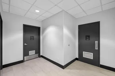 a hallway with two black doors and white walls at Holiday Inn Hotel & Suites Surrey East - Cloverdale by IHG in Surrey