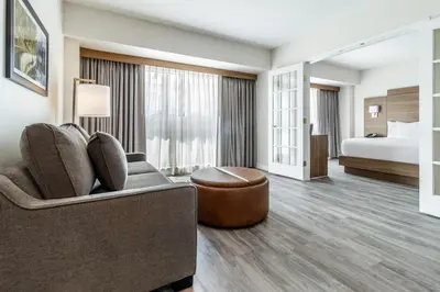 a hotel room with a couch and a bed at Atrium Hotel Vancouver in Vancouver