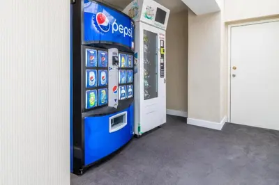 a pepsi machine in a room next to a door at Atrium Hotel Vancouver in Vancouver