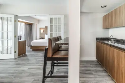 a hotel room with a desk and a bed at Atrium Hotel Vancouver in Vancouver