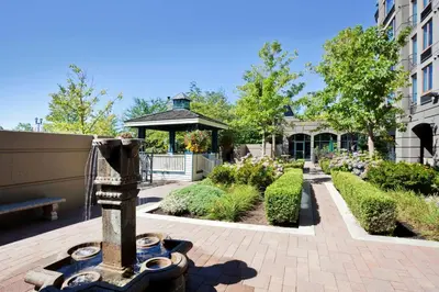a garden with a gazebo in the background at Holiday Inn & Suites North Vancouver by IHG in North Vancouver
