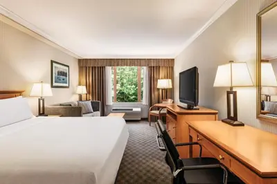 a hotel room with a bed and a desk and a television at Holiday Inn & Suites North Vancouver by IHG in North Vancouver
