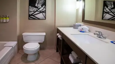 a bathroom with a toilet and a sink and a tub at Holiday Inn Express Vancouver-Metrotown (Burnaby) in Burnaby