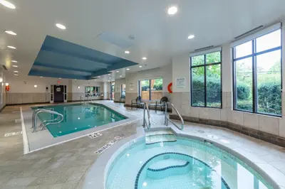 a large swimming pool in a large room with a swimming pool at Holiday Inn Express & Suites Riverport Richmond by IHG in Richmond