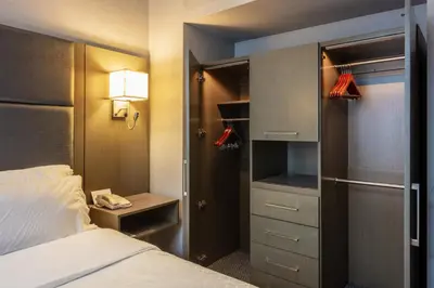 a hotel room with a bed and a closet at Holiday Inn Express & Suites Riverport Richmond by IHG in Richmond