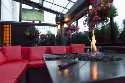 a living room with a red couch and a fire pit at Holiday Inn Vancouver Airport Richmond by IHG in Richmond