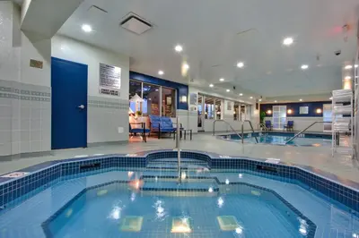a large swimming pool in a hotel room at Holiday Inn Calgary Airport by IHG in Calgary