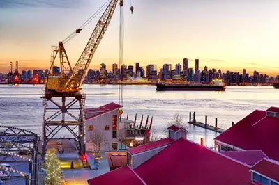 a view of a city skyline with a crane at Pinnacle Hotel at the Pier in North Vancouver