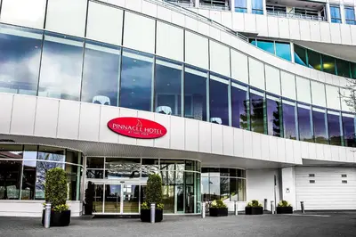 a building with a red sign on the side of it at Pinnacle Hotel at the Pier in North Vancouver