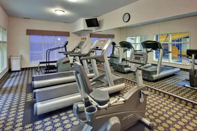 a gym with treadmills and machines in a room at Holiday Inn Express Hotel & Suites - Edmonton International Airport by IHG in Nisku
