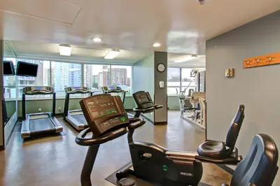 a gym with treadmills and cardio equipment in a building at Chateau Lacombe Hotel in Edmonton