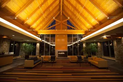 a lobby with chairs and a fireplace in a building at Edmonton Hotel & Convention Center Edmonton in Edmonton