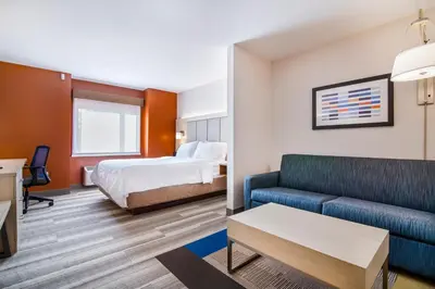a hotel room with a bed and a couch at Holiday Inn Express & Suites Langley by IHG in Langley
