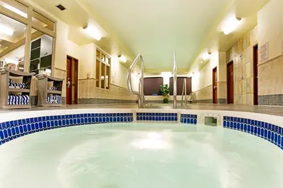a large swimming pool in a hotel room at Holiday Inn Hotel & Suites-West Edmonton by IHG in Edmonton