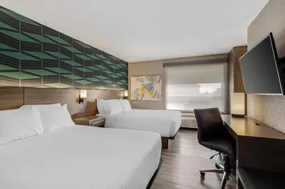 a hotel room with two beds and a desk at Best Western Plus West Edmonton in Edmonton