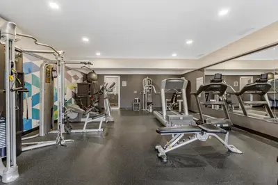 a gym with several treadmills and exercise machines at Best Western Plus West Edmonton in Edmonton