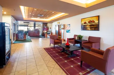 a waiting room in a hospital with chairs and a table at Holiday Inn Hinton by IHG in Hinton