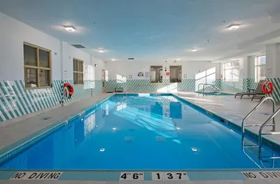 a large swimming pool with blue water in a building at Holiday Inn Hotel and Suites-Kamloops by IHG in Kamloops