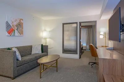 a living room with a couch and a table at Holiday Inn Hotel and Suites-Kamloops by IHG in Kamloops