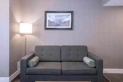 a living room with a couch and a picture on the wall at Sandman Signature Calgary Downtown Hotel in Calgary
